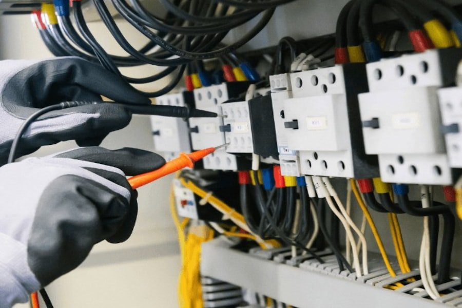 Electrician testing a distribution panel with a multimeter